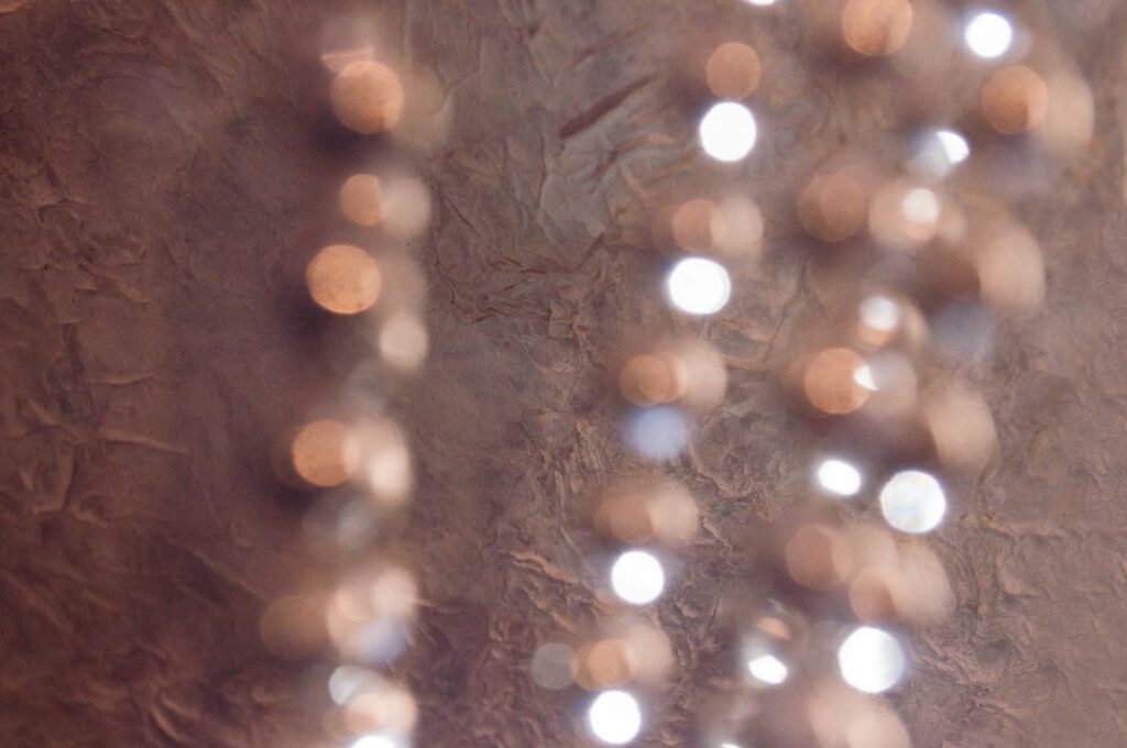 A close up of a beaded necklace on a table